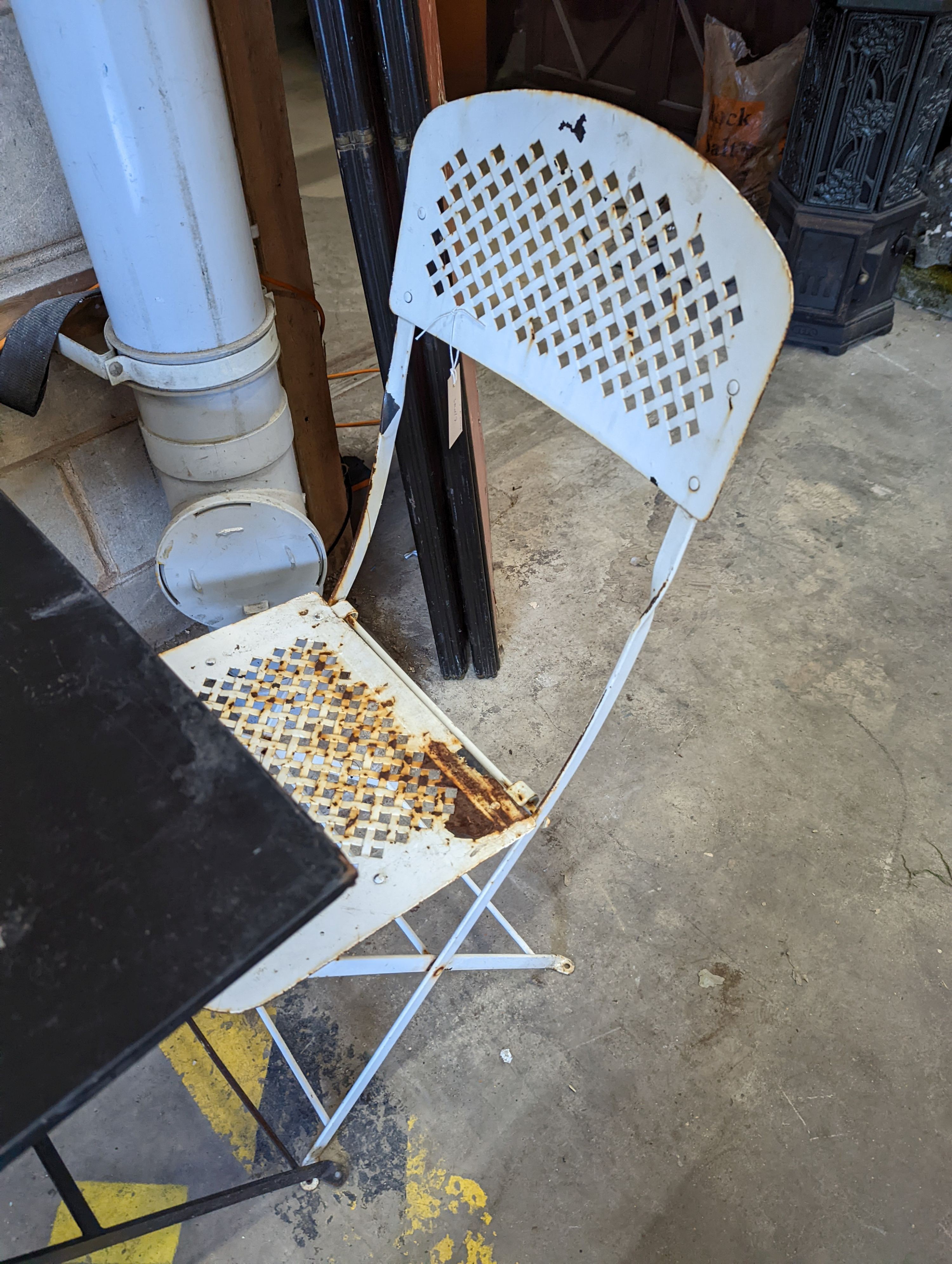 A square metal folding bistro table, width 60cm, height 71cm, together with two metal chairs